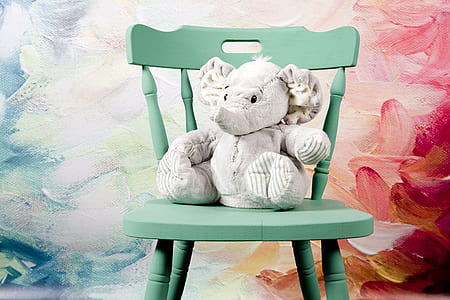 white elephant plush toy on teal wooden windsor chair thumbnail