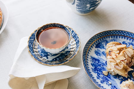 blue and white ceramic teacup on top of plate thumbnail