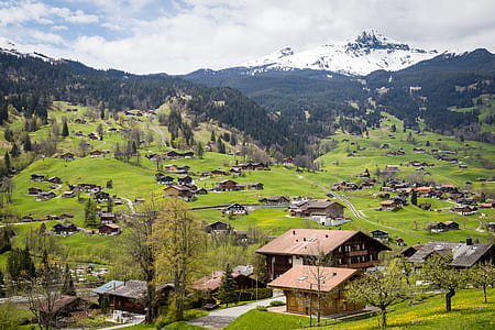 aerial photography of brown house near mountain at daytime thumbnail