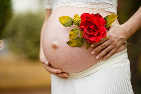 woman wearing white skirt holding red rose thumbnail