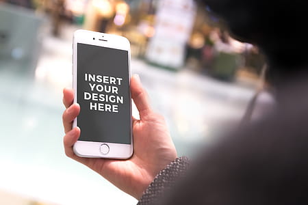 Free PSD Mockup. Woman in a shopping center using his iPhone 7 thumbnail