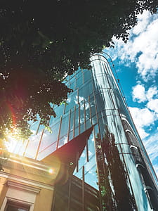 Low Angle Photo of High-rise Building over Blue and Cloudy Sky at Daytime thumbnail