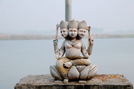 3-head Buddha statue near body of water thumbnail