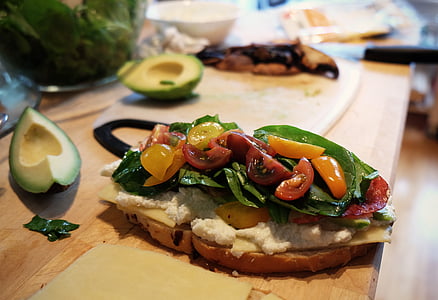 bread with cream and roasted tomatoes on brown wooden table thumbnail