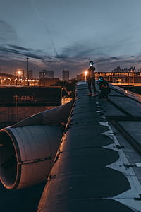two man standing on airplane's wing thumbnail