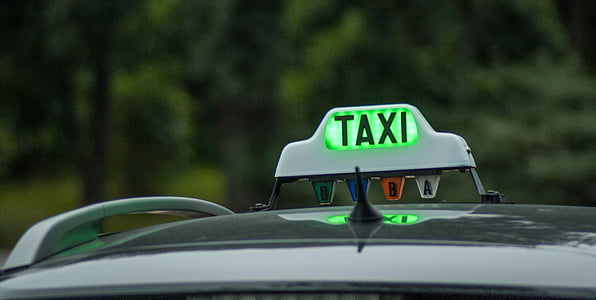selective focus photography of Taxi signage turned-on thumbnail