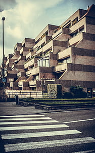 beige building under white clouds thumbnail