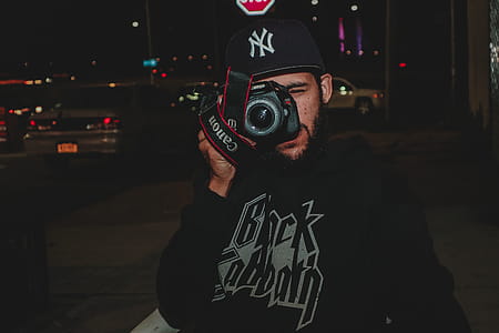 Man Taking Picture Using Canon Dslr Camera thumbnail