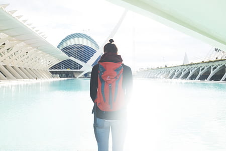 person with hands on pocket facing swimming pool thumbnail