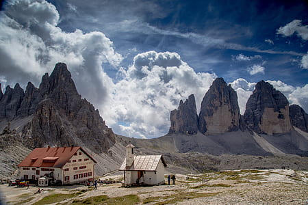 cathedral and house near rock formation thumbnail