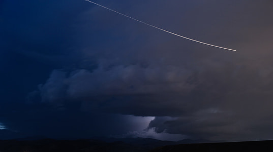 aerobatic plane in the sky with white smoke trail thumbnail