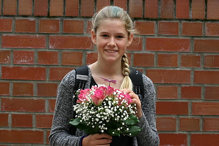 woman holding bouquet of pink roses smiling thumbnail
