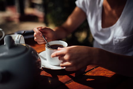 person holding coffee mug thumbnail
