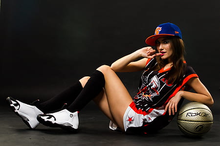 woman in black jersey leaning in gold basketball thumbnail