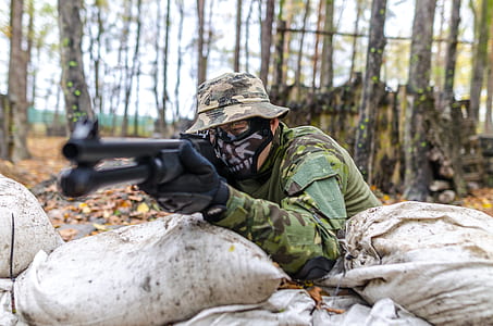 Soldier Holding a Rifle at Daytime thumbnail