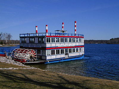 white and red passenger vessel docked on body of water thumbnail