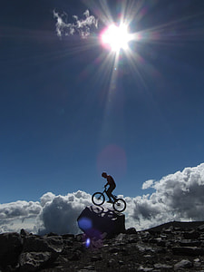 silhouette photo of man riding on bike at daytime thumbnail