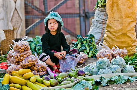 girl sitting in front of vegetables thumbnail