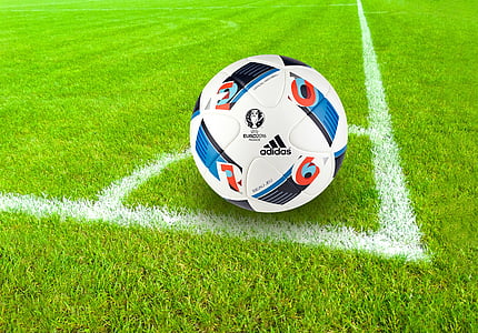 white Adidas soccer ball on field thumbnail