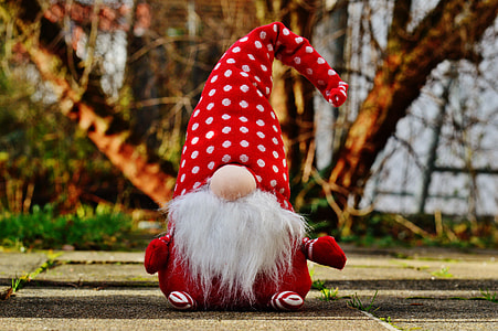 gnome plush toy placed on gray pavement thumbnail