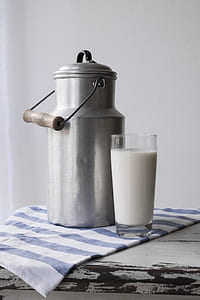silver milk churn near clear highball glass thumbnail
