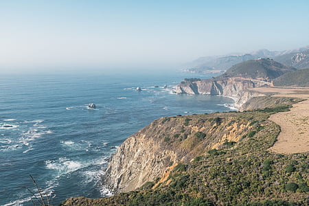 bird's eye view of cliff over body of water thumbnail