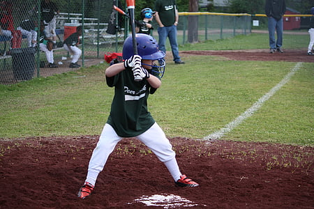 child playing baseball during daytime thumbnail