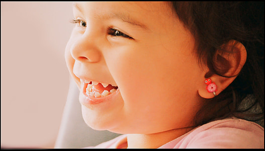 baby girl smiling wearing pink top during daytime thumbnail