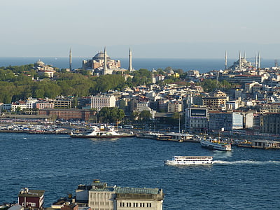 aerial view of city beside body of water thumbnail