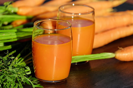 two clear drinking glasses with orange liquid thumbnail