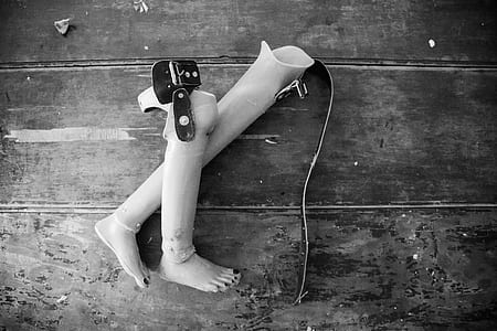 Two Prosthetic Legs on Wooden Surface thumbnail