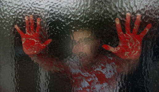 person holding glass with bloody hands thumbnail