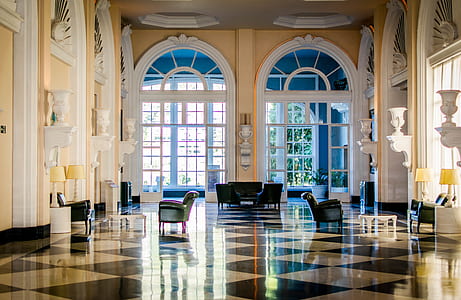 black leather sofas and sofa chairs inside building thumbnail