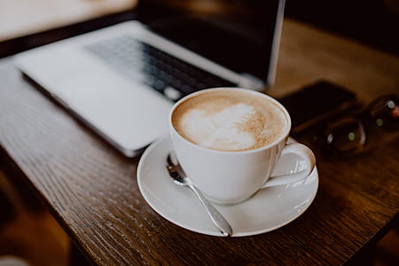 Cup of coffee on table in cafe thumbnail