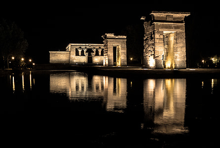 stone building near body of water during night light thumbnail
