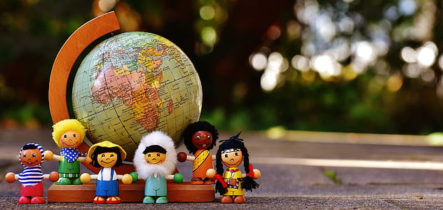shallow focus on kids plastic toy surrounding desk globe thumbnail