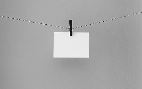 black clothespin with white paper thumbnail