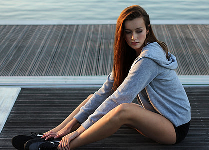 Girl in gray hoodie sitting on the dock thumbnail