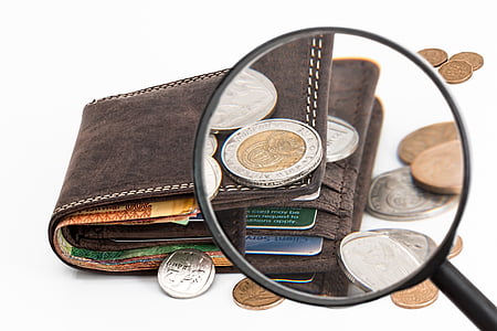 black magnifying glass and brown leather bi-fold wallet thumbnail