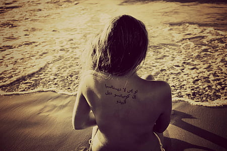grayscale photo of woman near body of water thumbnail