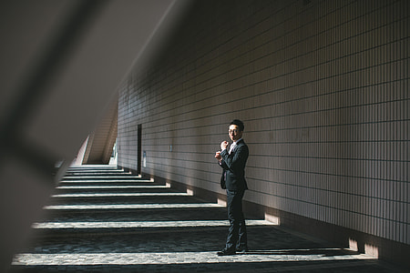 man standing near to wall thumbnail
