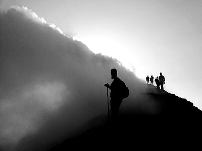 silhouette of people standing near cloud formation thumbnail