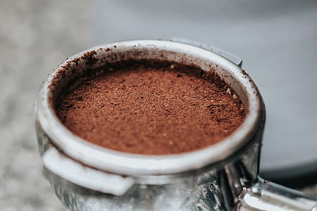 brown powder inside round gray container close-up photography thumbnail