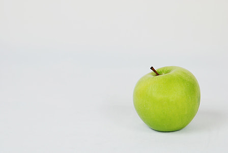 minimalist photography of green apple on white background thumbnail