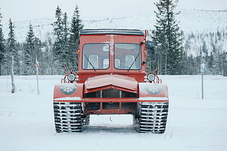 red tractor on pathway coated snow thumbnail
