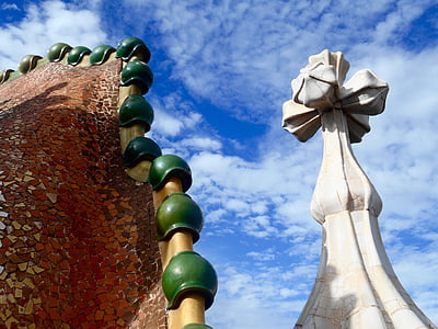 brown and green mosaic glass structure beside white tower low-angle photography thumbnail