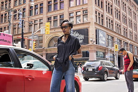 woman walking beside red car thumbnail