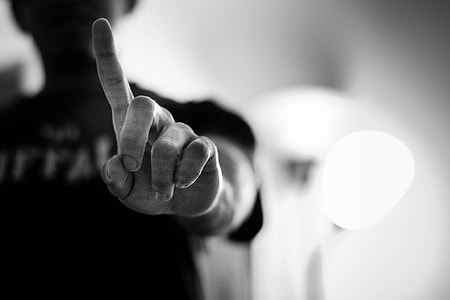 grascale photography of person in black top standing near light thumbnail