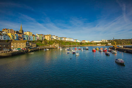 boats on water near city buildings thumbnail