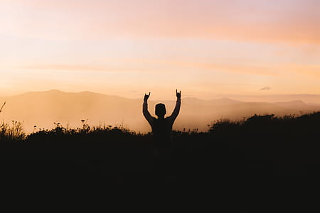 silhouette of man raising hands thumbnail